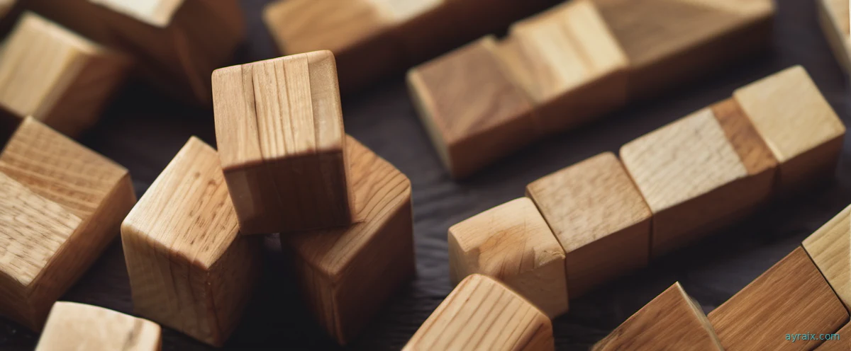 A stack of wooden toy blocks toppling and collapsing, sprawl-versus-focus metaphor