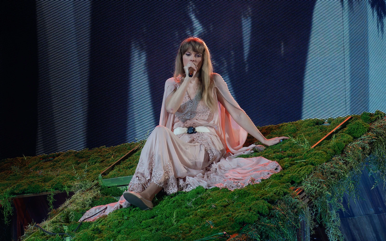 Taylor Swift in the Folklore cabin set of The Eras Tour in Arlington, Texas