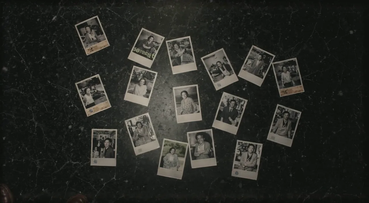 Sixty polaroid photographs scattered on a dark floor