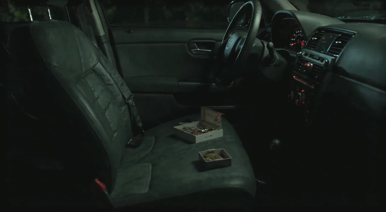 An empty car passenger seat with the seatbelt fastened
