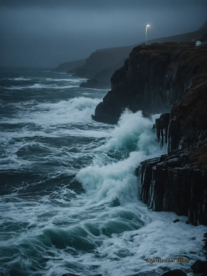 A winter sea under a storm, white spray against black water.